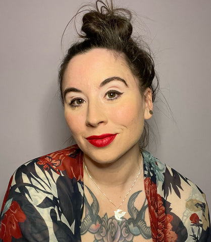 Headshot of Erica Smith wearing a messy bun and red lipstick