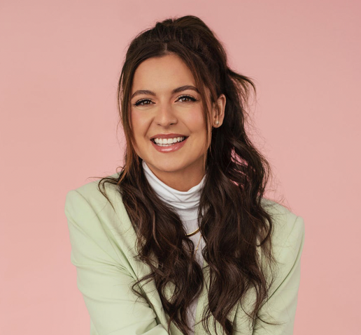 Karine St-Michel wearing a white turtleneck and mint jacket smiling into the camera