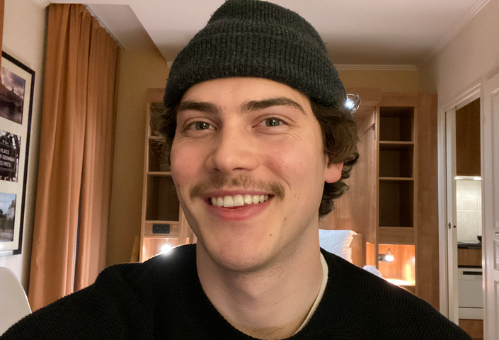 Jack Innanen wearing a toque and black shirt smiling into the camera