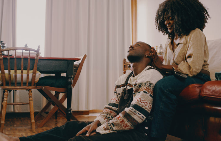 Woman massaging her partner's head in the comfort of their home