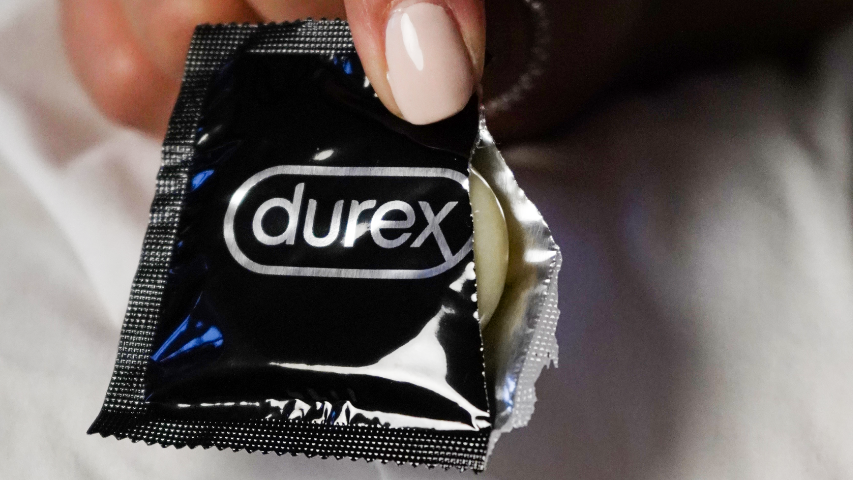 Durex Avanti Bare Ultra Thin condom package being opened.
