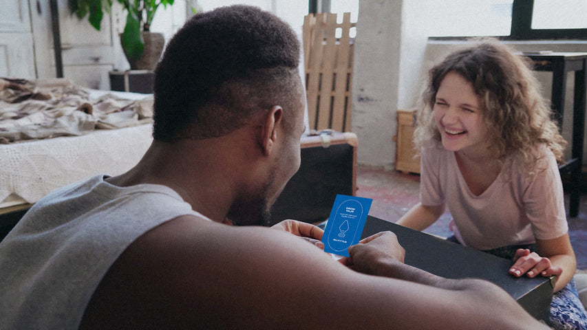 Two people playing the Durex card game together