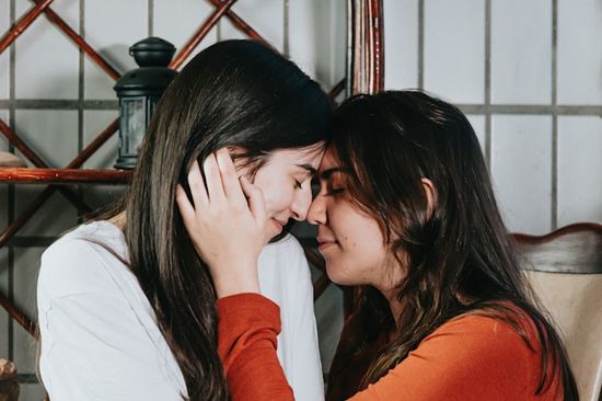 People touching each other forehead